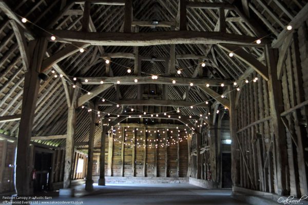 festoon wedding lightin g in barn